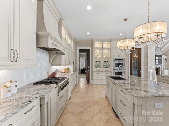 kitchen with custom range hood, stainless steel appliances, pendant lighting, a chandelier, and a large island