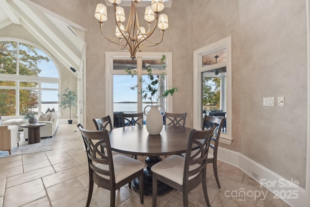 dining room featuring a notable chandelier and lofted ceiling