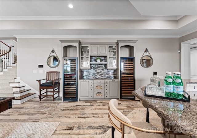 kitchen featuring backsplash, gray cabinets, beverage cooler, and ornamental molding