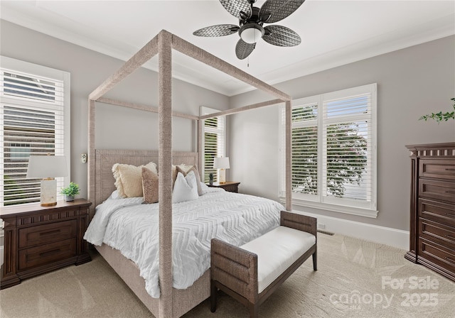 carpeted bedroom featuring multiple windows, ceiling fan, and ornamental molding