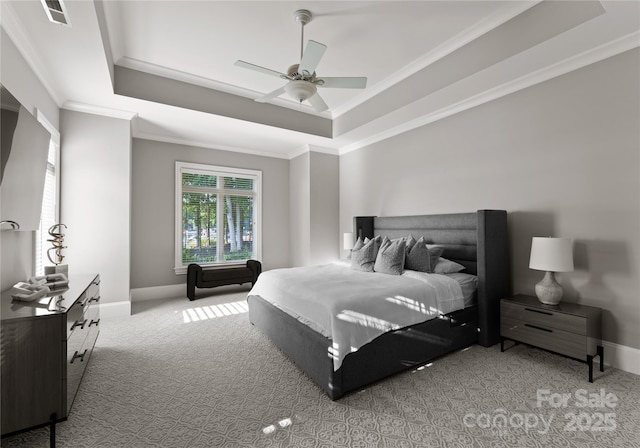 carpeted bedroom featuring a raised ceiling, ceiling fan, and crown molding