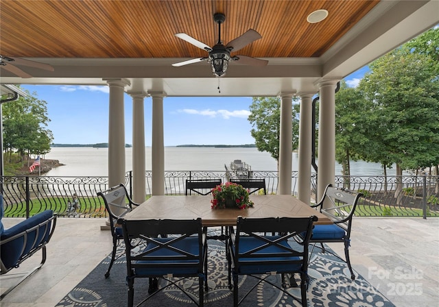 view of patio / terrace with a water view and ceiling fan