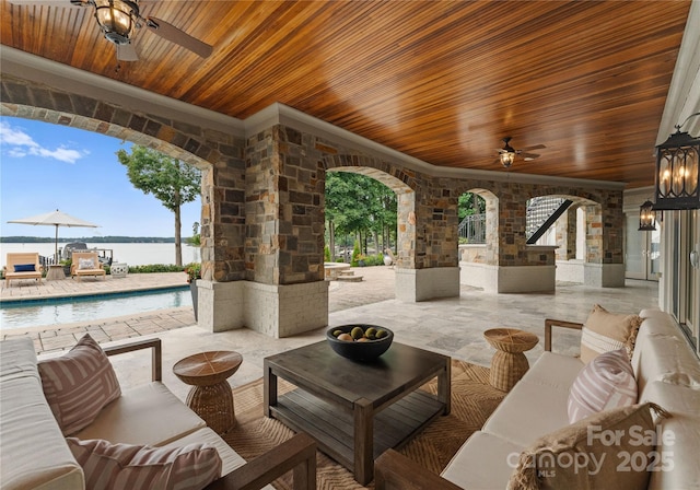 view of patio featuring an outdoor hangout area, a water view, and ceiling fan