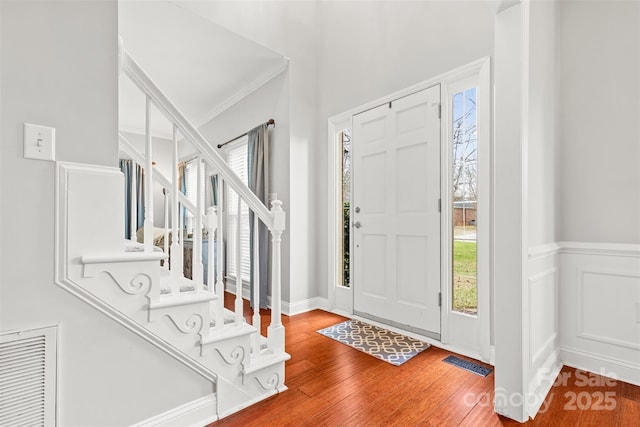 entryway featuring hardwood / wood-style floors and ornamental molding