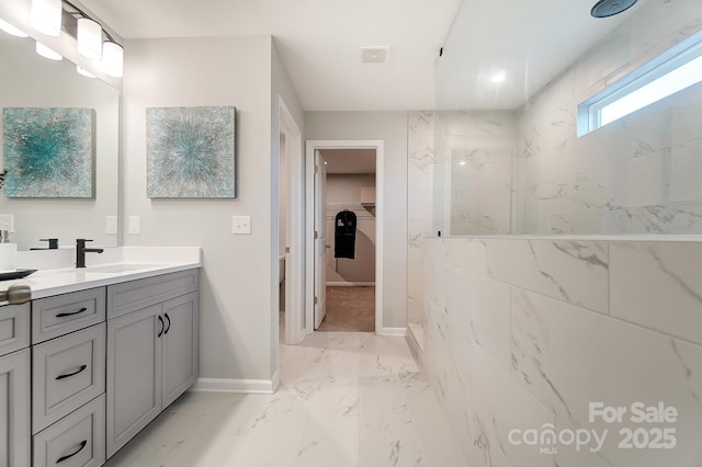 bathroom featuring vanity and a tile shower