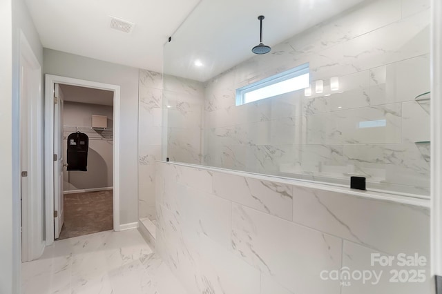 bathroom with a tile shower