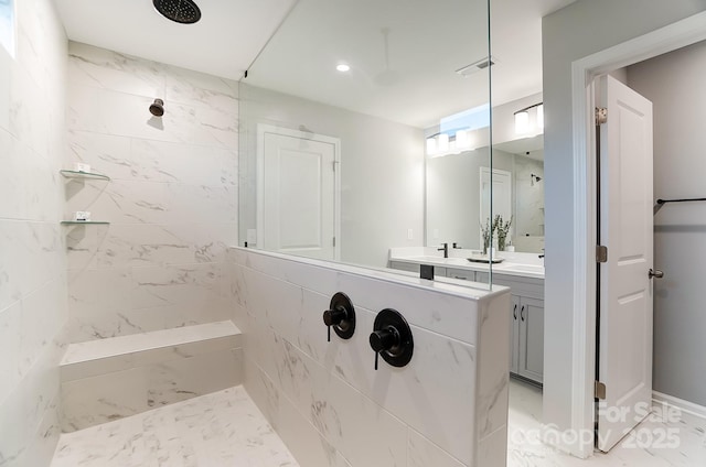 bathroom featuring vanity and tiled shower