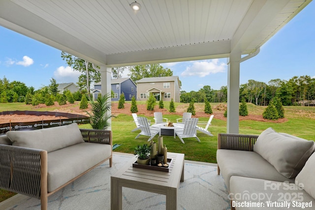 view of patio / terrace featuring an outdoor living space with a fire pit