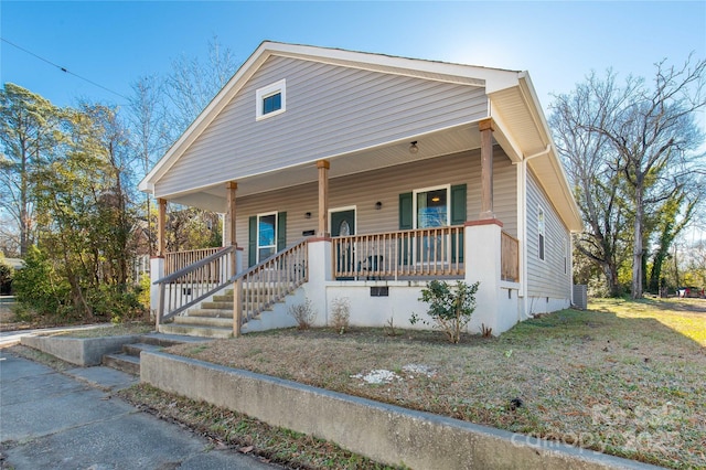 view of front of property with a porch and a front lawn