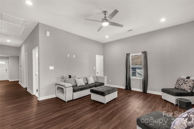 living room featuring ceiling fan and dark wood-type flooring