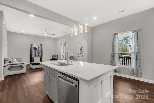 kitchen with a center island with sink, ceiling fan, pendant lighting, sink, and stainless steel dishwasher