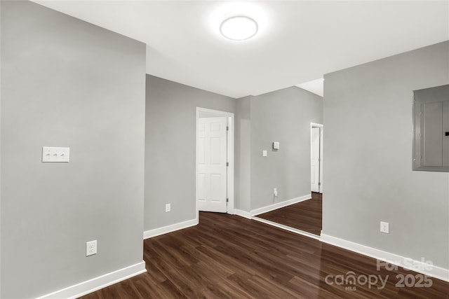 unfurnished room featuring dark hardwood / wood-style flooring and electric panel