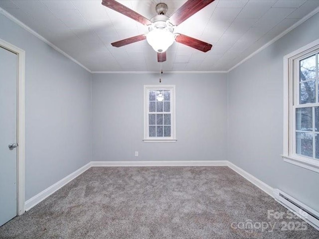 empty room featuring carpet flooring, crown molding, ceiling fan, and a baseboard heating unit