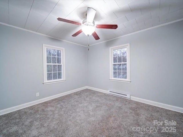 spare room with ceiling fan, baseboard heating, crown molding, and carpet floors