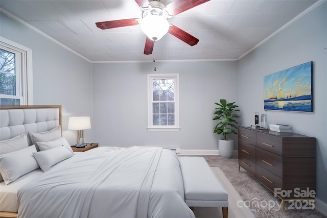 carpeted bedroom featuring ceiling fan and crown molding