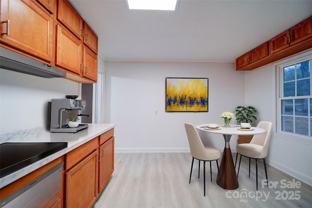 dining room with crown molding and light hardwood / wood-style flooring