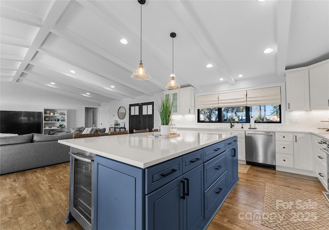 kitchen with blue cabinetry, wine cooler, white cabinetry, and stainless steel dishwasher