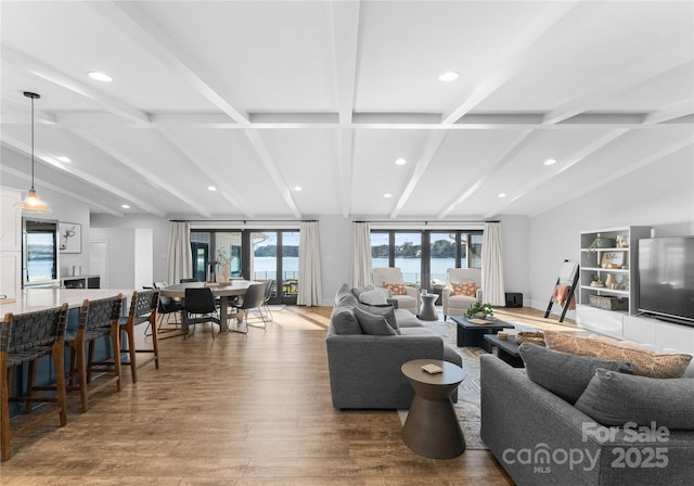 living room featuring hardwood / wood-style floors and lofted ceiling with beams