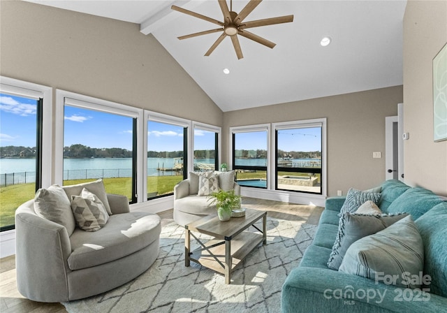 living room with high vaulted ceiling, a water view, ceiling fan, beamed ceiling, and plenty of natural light