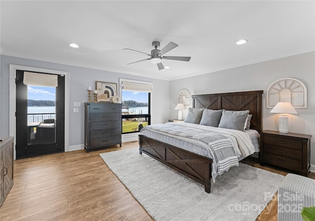 bedroom featuring a water view, ceiling fan, access to exterior, multiple windows, and light hardwood / wood-style floors