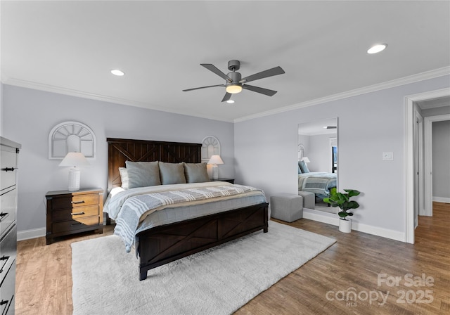 bedroom featuring ceiling fan, wood-type flooring, and ornamental molding