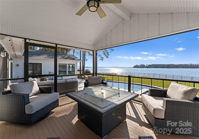 wooden deck featuring an outdoor living space and a water view