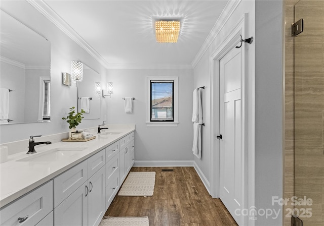 bathroom featuring crown molding, vanity, and wood-type flooring