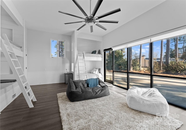 bedroom featuring access to exterior, ceiling fan, dark hardwood / wood-style flooring, and multiple windows