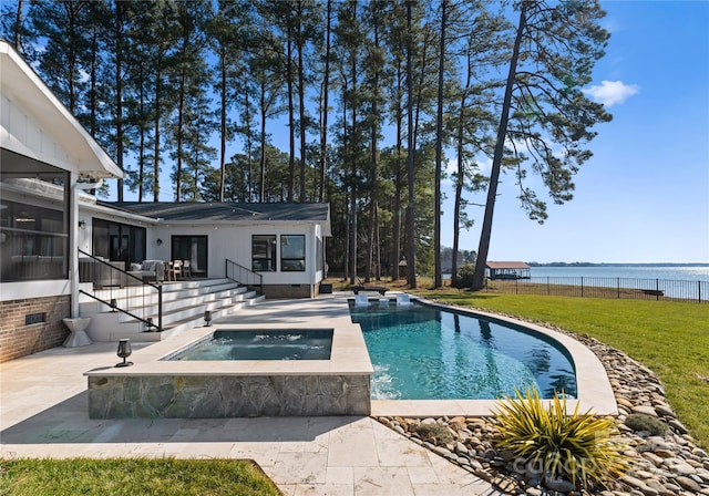 view of pool with a lawn, a sunroom, an in ground hot tub, a water view, and a patio