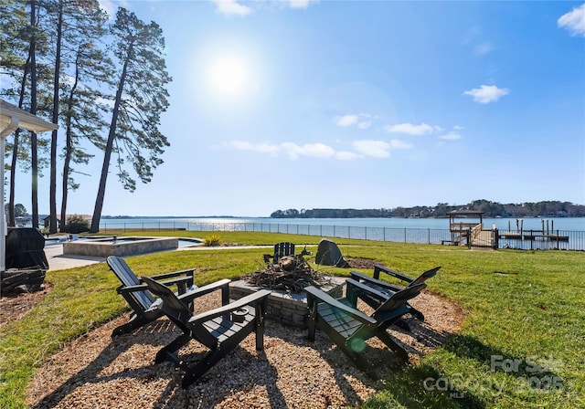 view of yard with a water view and an outdoor fire pit