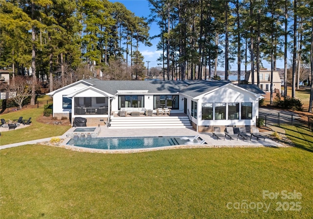 back of property featuring a lawn, a sunroom, a patio, and an outdoor living space