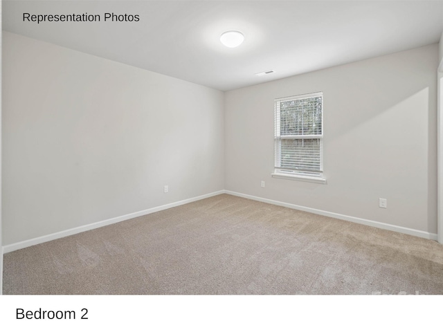 unfurnished room with light colored carpet