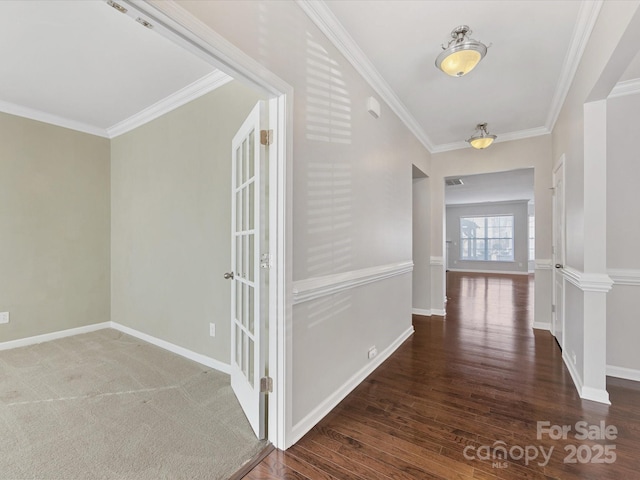 hall with dark hardwood / wood-style flooring and crown molding