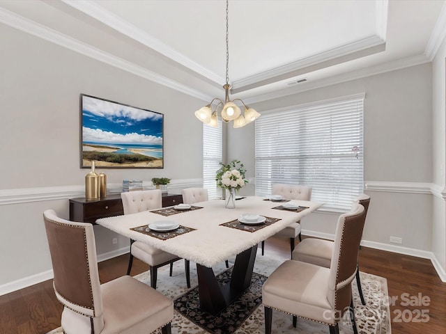 dining room featuring dark wood-type flooring, plenty of natural light, and ornamental molding