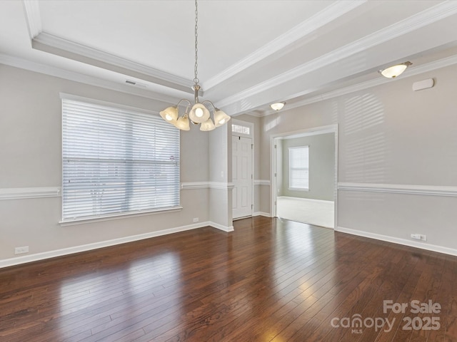 spare room featuring a raised ceiling, dark hardwood / wood-style flooring, ornamental molding, and an inviting chandelier