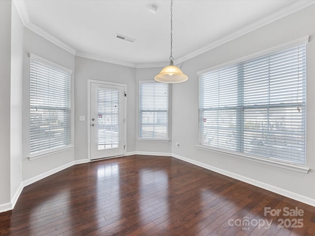 unfurnished dining area featuring crown molding and dark wood-type flooring