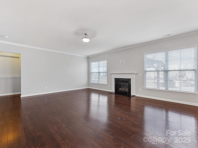 unfurnished living room featuring dark hardwood / wood-style flooring and crown molding