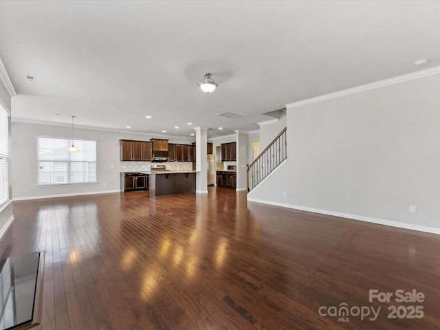 unfurnished living room featuring crown molding and dark hardwood / wood-style flooring