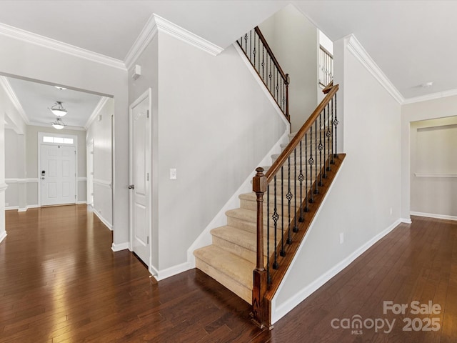 staircase featuring hardwood / wood-style floors and crown molding