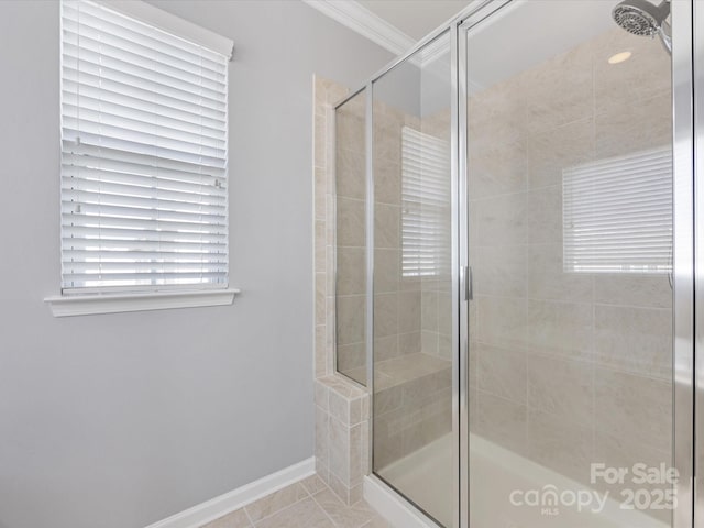 bathroom featuring tile patterned floors, a shower with shower door, and crown molding