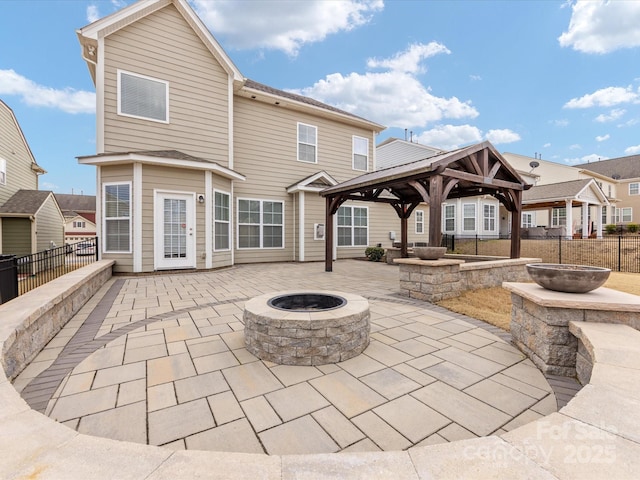 back of house with a gazebo, a patio, and an outdoor fire pit