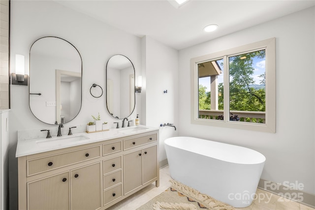 bathroom featuring tile patterned floors, a bathtub, and vanity