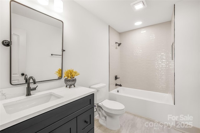 full bathroom with vanity, toilet, and tiled shower / bath