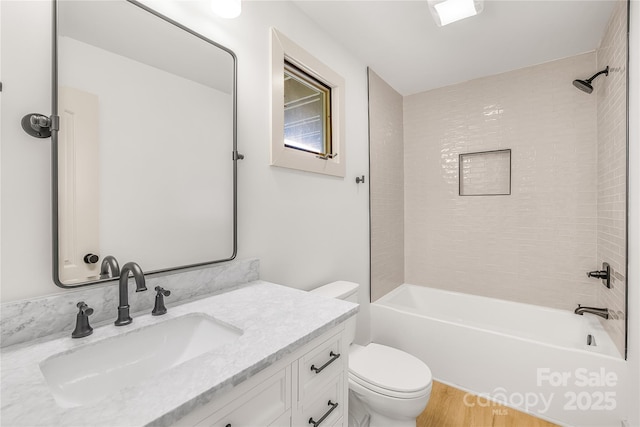 full bathroom with shower / bathing tub combination, vanity, toilet, and hardwood / wood-style flooring