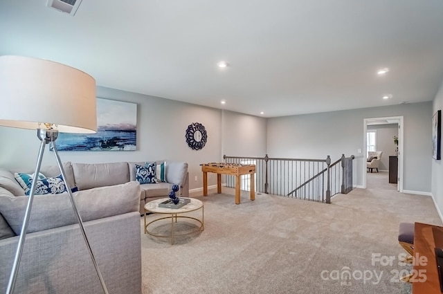 carpeted living room with recessed lighting, visible vents, and baseboards