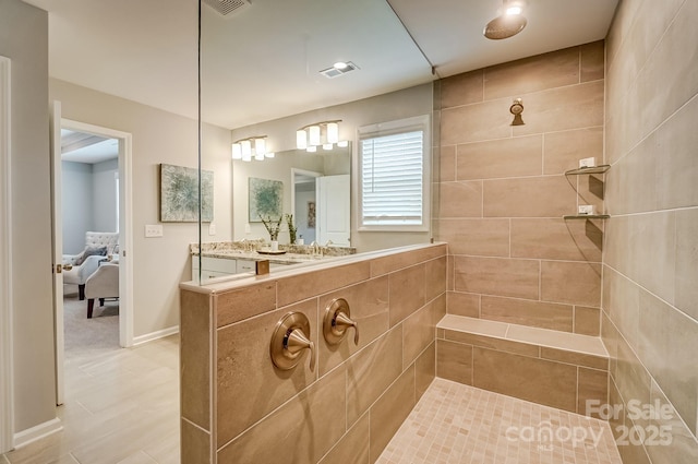 bathroom featuring baseboards, visible vents, a walk in shower, and ensuite bathroom