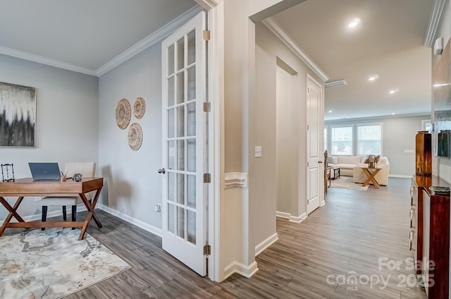 office area with baseboards, visible vents, ornamental molding, and wood finished floors