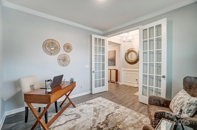 office space with crown molding, baseboards, wood finished floors, and french doors