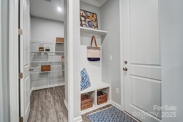 mudroom featuring baseboards and wood finished floors