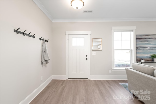 entryway featuring ornamental molding and light hardwood / wood-style floors